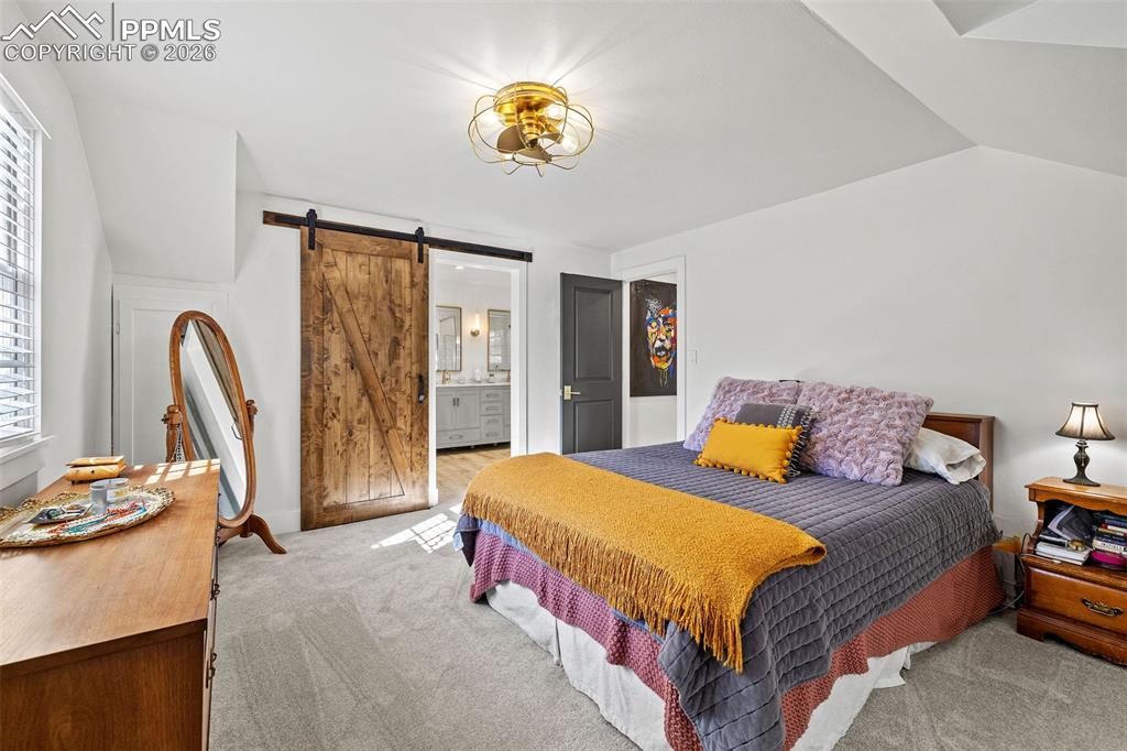 2 Cresta Road Colorado Springs, CO 80906 - Photo 17 of 33 a bedroom with a bed and a chandelier