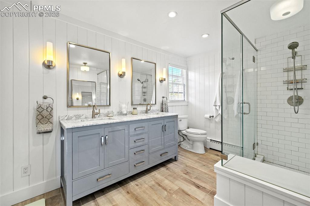 2 Cresta Road Colorado Springs, CO 80906 - Photo 18 of 33 a bathroom with a double vanity sink toilet mirror and bathtub