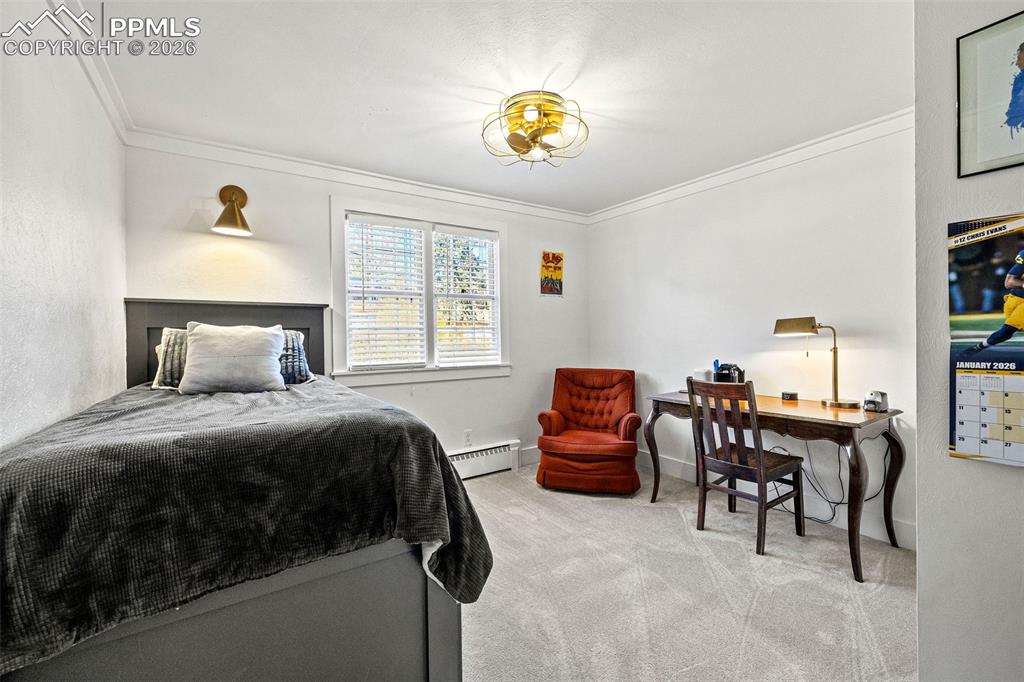 2 Cresta Road Colorado Springs, CO 80906 - Photo 20 of 33 a bedroom with a bed and a chandelier