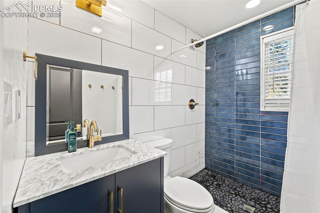 2 Cresta Road Colorado Springs, CO 80906 - Photo 29 of 33 a bathroom with a granite countertop sink toilet and shower