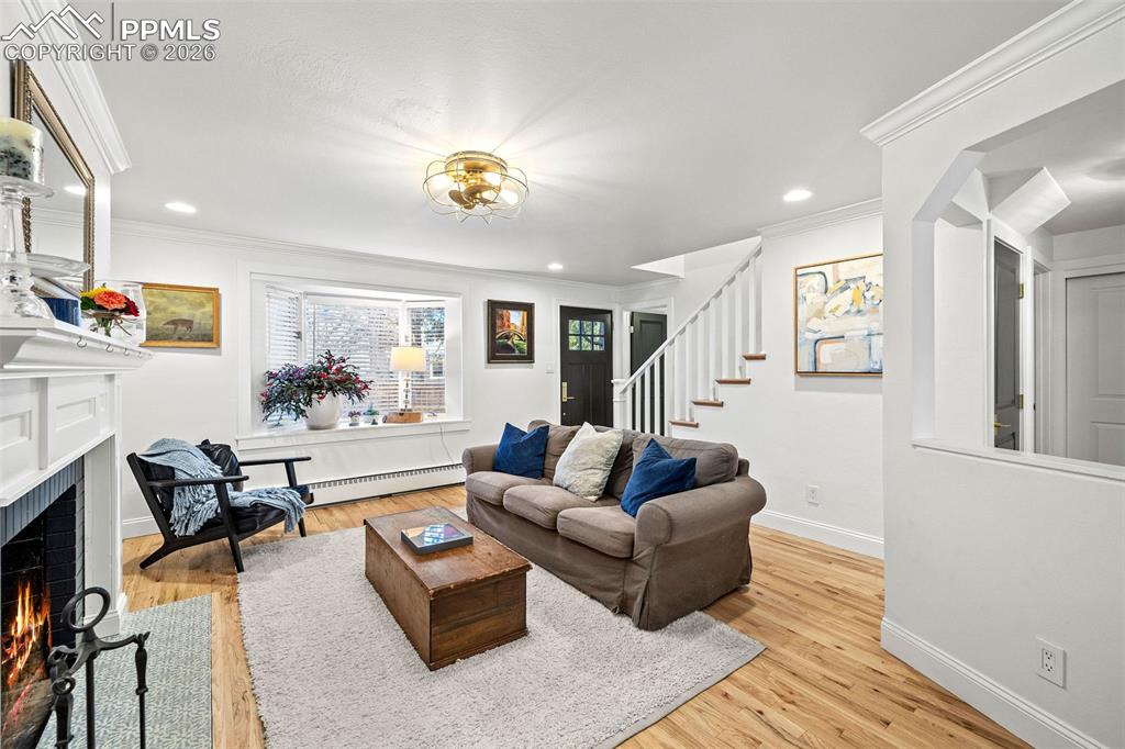 2 Cresta Road Colorado Springs, CO 80906 - Photo 5 of 33 a living room with furniture and a wooden floor
