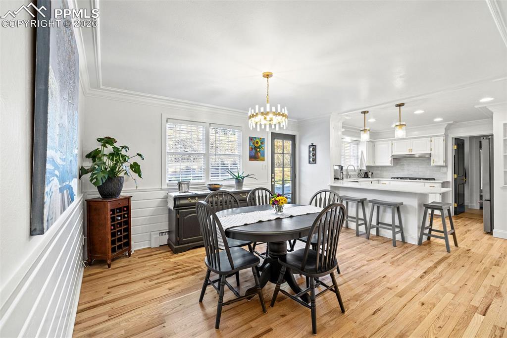 2 Cresta Road Colorado Springs, CO 80906 - Photo 7 of 33 a view of a dining room with furniture window and wooden floor