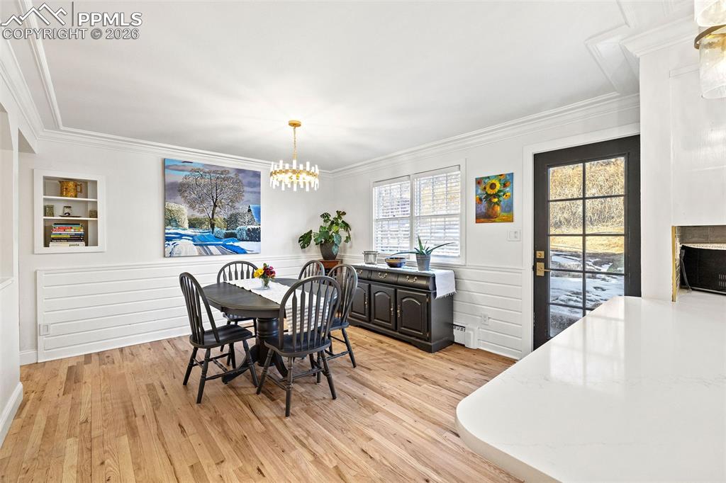2 Cresta Road Colorado Springs, CO 80906 - Photo 9 of 33 a view of a dining room with furniture and wooden floor