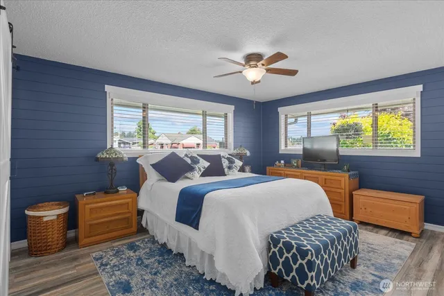 a bedroom with a bed and wooden floor