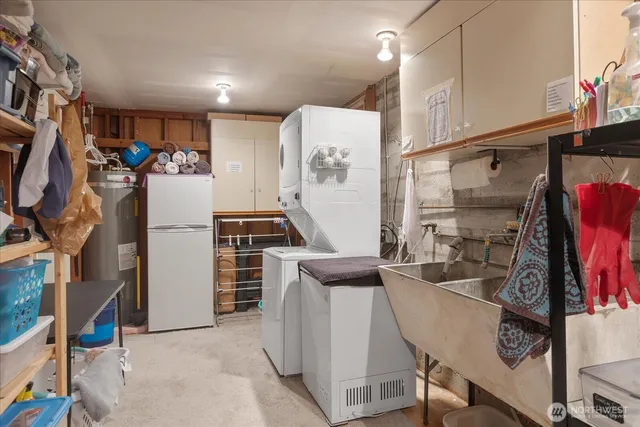a view of a kitchen with fridge and workspace