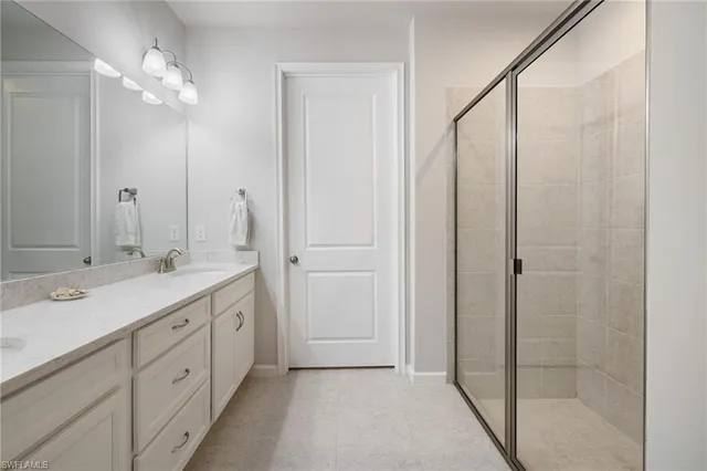 a bathroom with double sink and a mirror