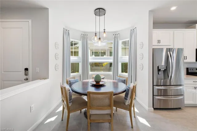 a dining room with furniture a chandelier and window