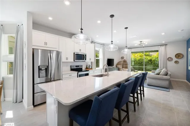 a large kitchen with a table and chairs