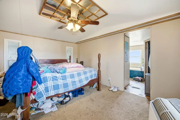 a bedroom with a bed and a chandelier