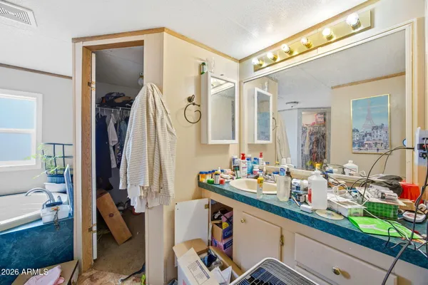 a bathroom with a sink mirror and vanity