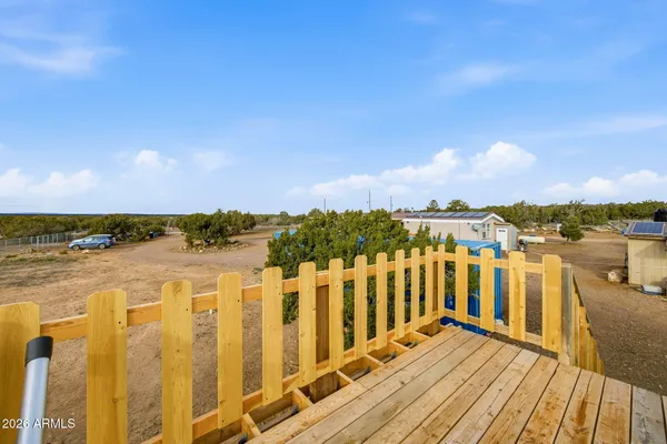 a view of a balcony with wooden floor and lake view