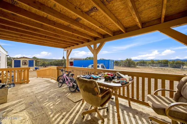 a view of a patio with couches chairs and wooden floor