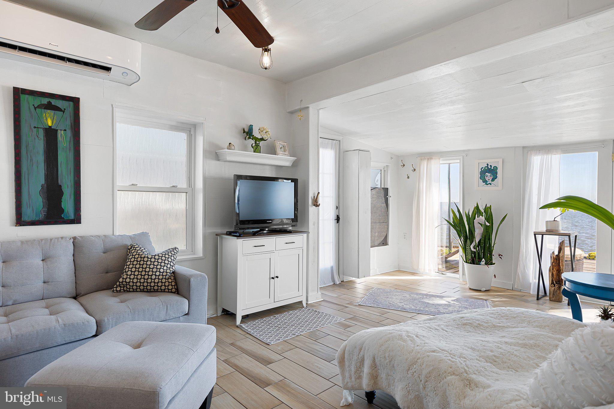 9 South New Road Middletown, DE 19709 - Photo 16 of 41 a bedroom with a balcony a bed and a television