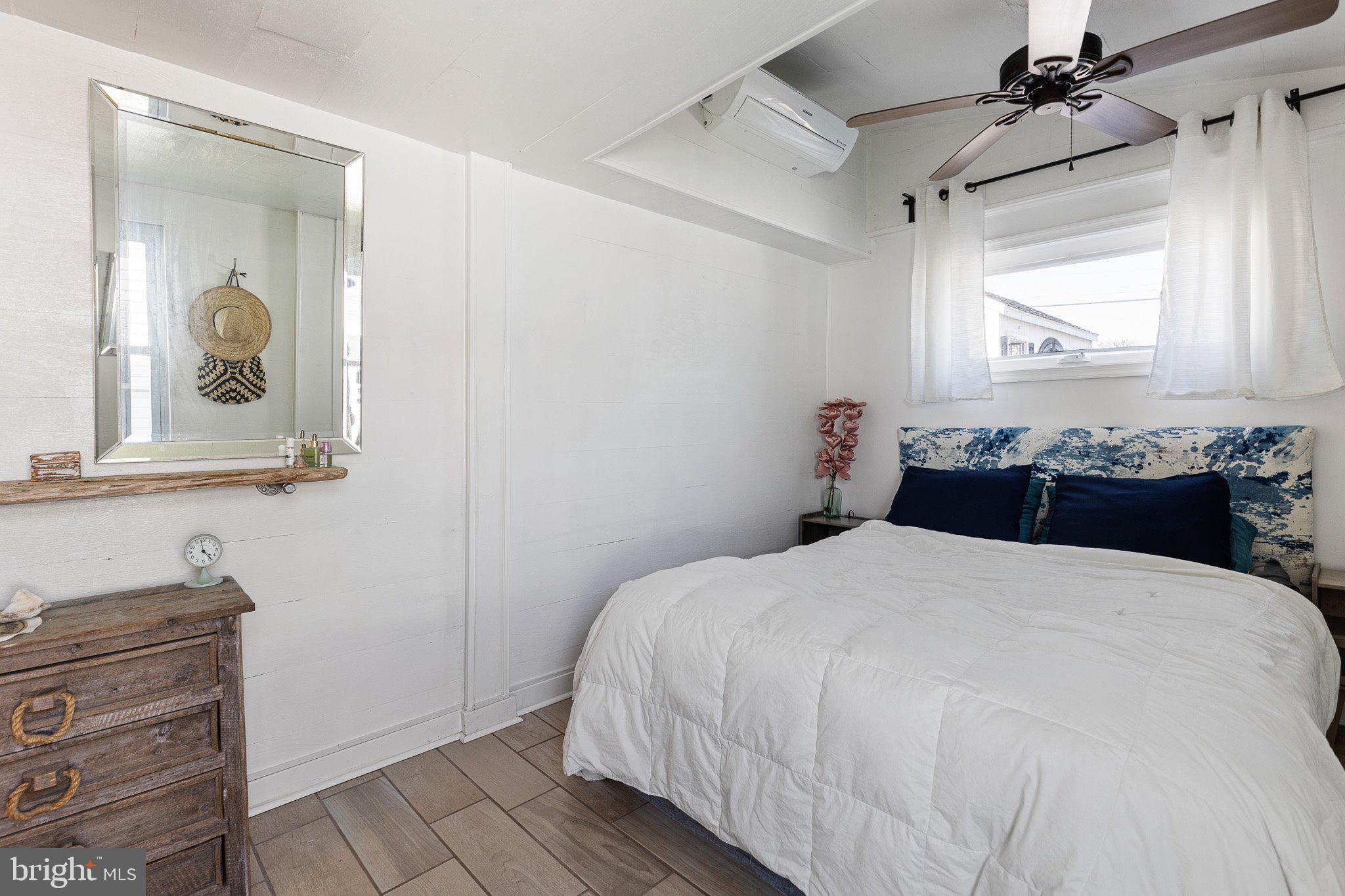 9 South New Road Middletown, DE 19709 - Photo 23 of 41 a bedroom with a bed and a mirror on the dresser