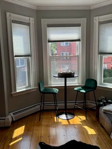 a living room with furniture pool table and a window