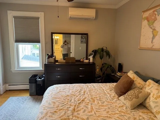 a bedroom with a bed window and wall painting