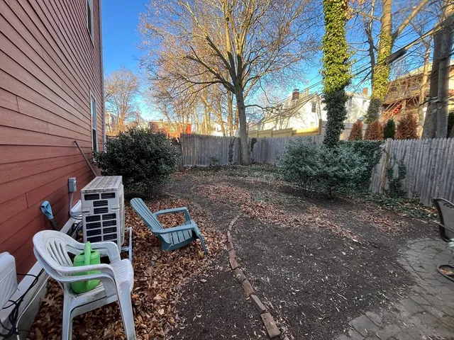 a view of a chairs and table in backyard