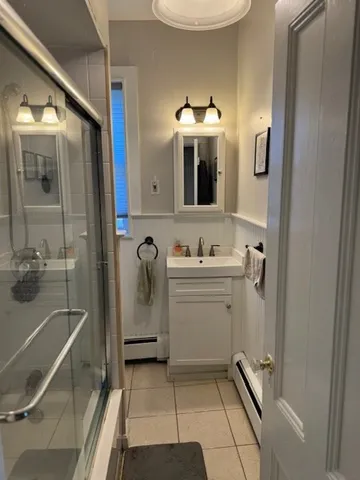 a bathroom with a sink a toilet and mirror