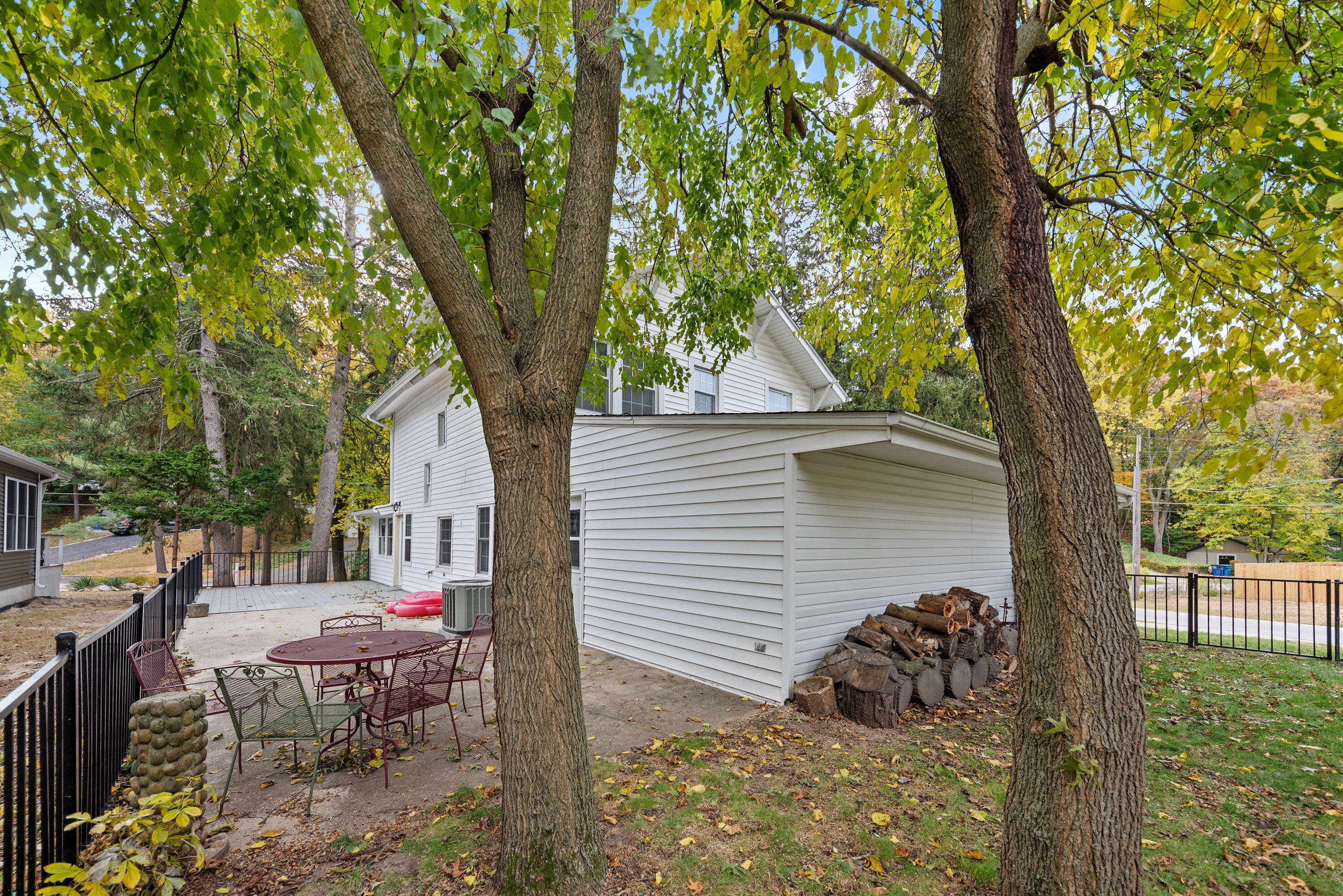 2005 Oriole Trail Long Beach, IN 46360 - Photo 22 of 23 a view of backyard with a table and chairs and a large tree