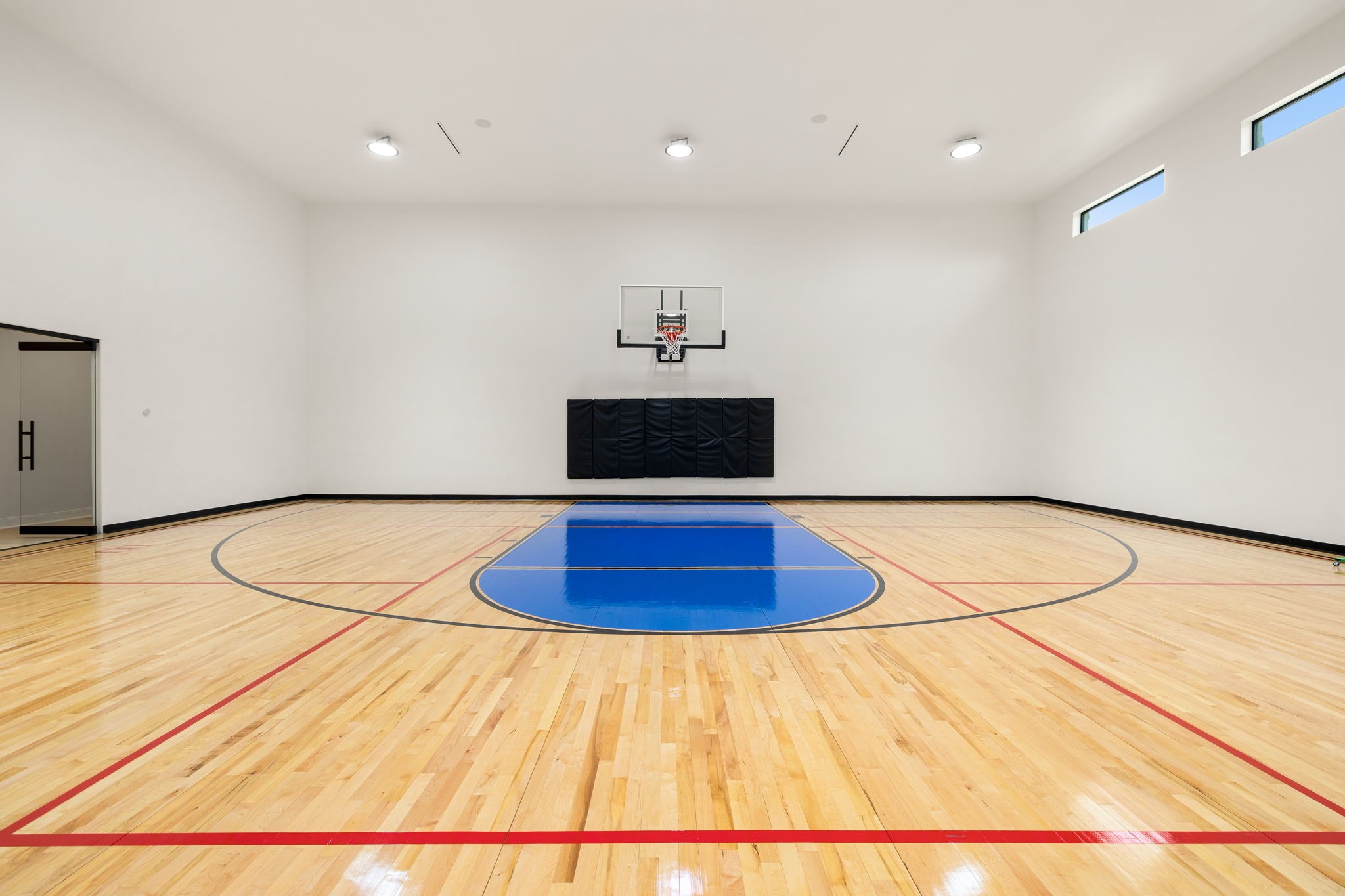 1100 Felder Road Washington, TX 77880 - Photo 36 of 50 At the heart of the estate's private recreation wing, the indoor basketball court is complemented by an adjoining fitness studio and versatile upper-level flex space.