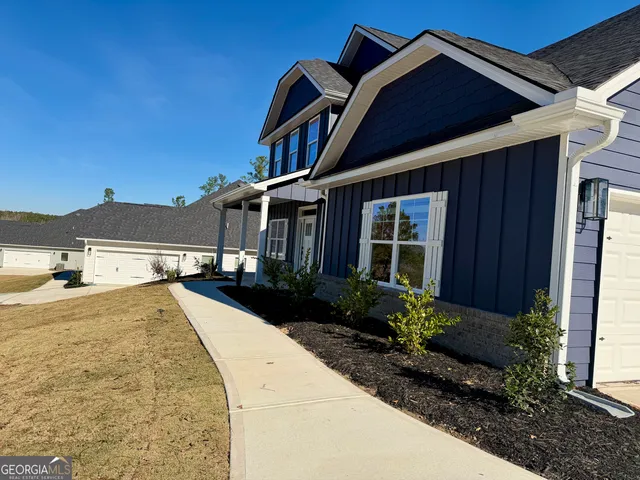 a front view of a house with garden
