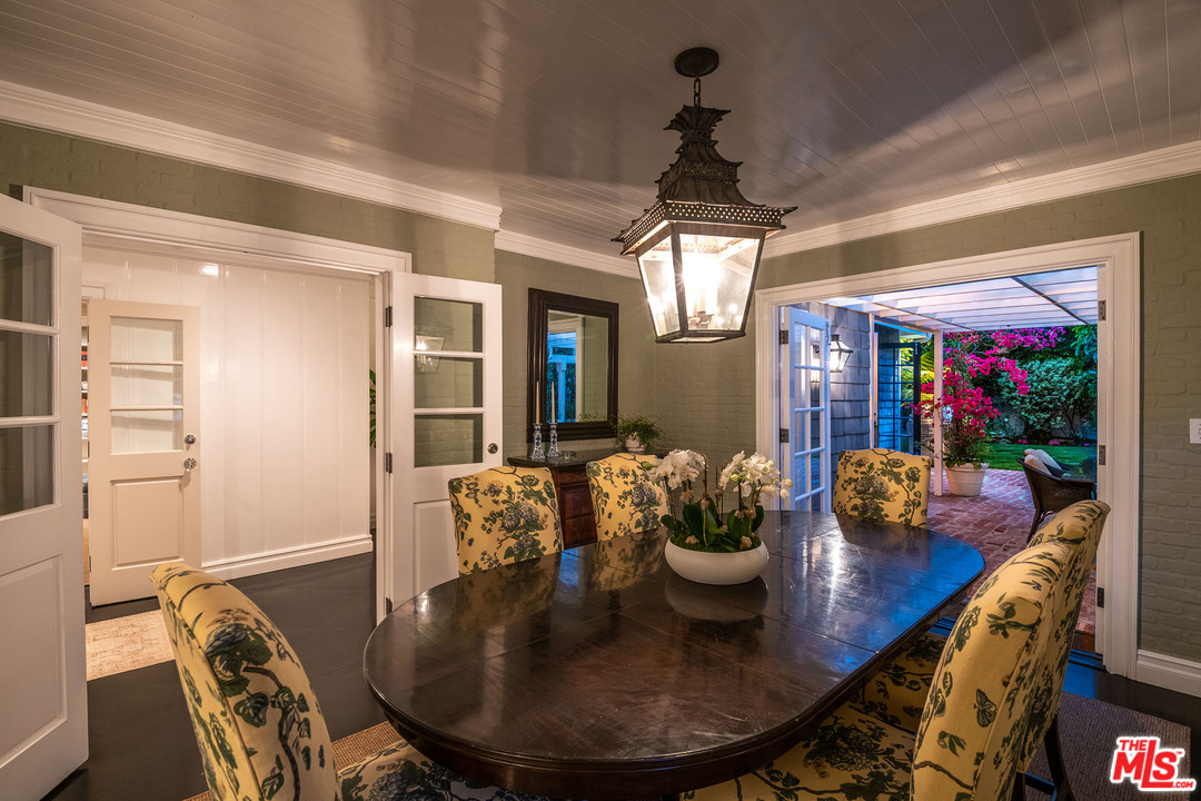 120 Homewood Road Los Angeles, CA 90049 - Photo 11 of 47 a view of a dining room with furniture and chandelier