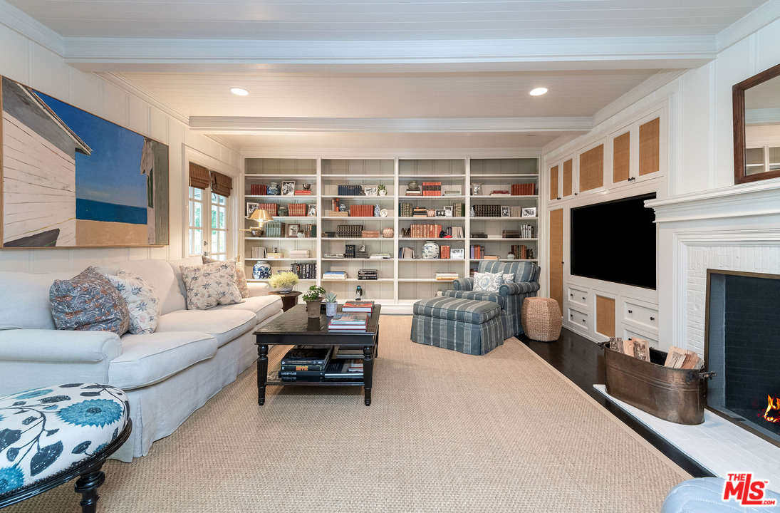 120 Homewood Road Los Angeles, CA 90049 - Photo 23 of 47 a living room with furniture a flat screen tv and a fireplace