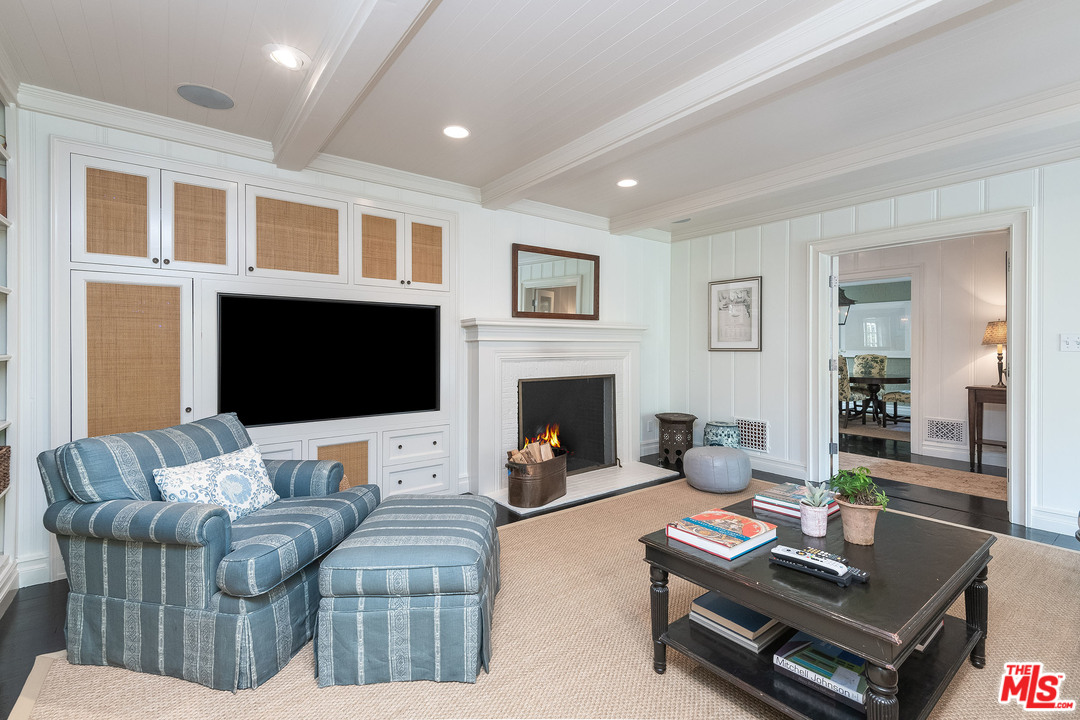 120 Homewood Road Los Angeles, CA 90049 - Photo 25 of 47 a living room with furniture a rug and a fireplace