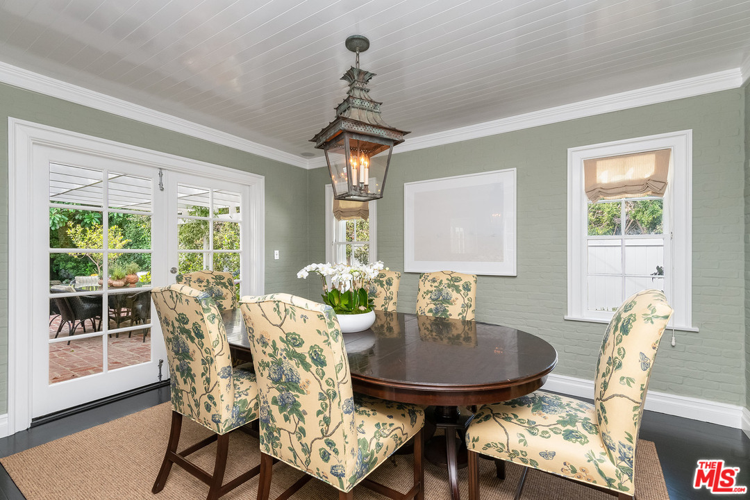 120 Homewood Road Los Angeles, CA 90049 - Photo 32 of 47 a dining room with furniture a chandelier and wooden floor