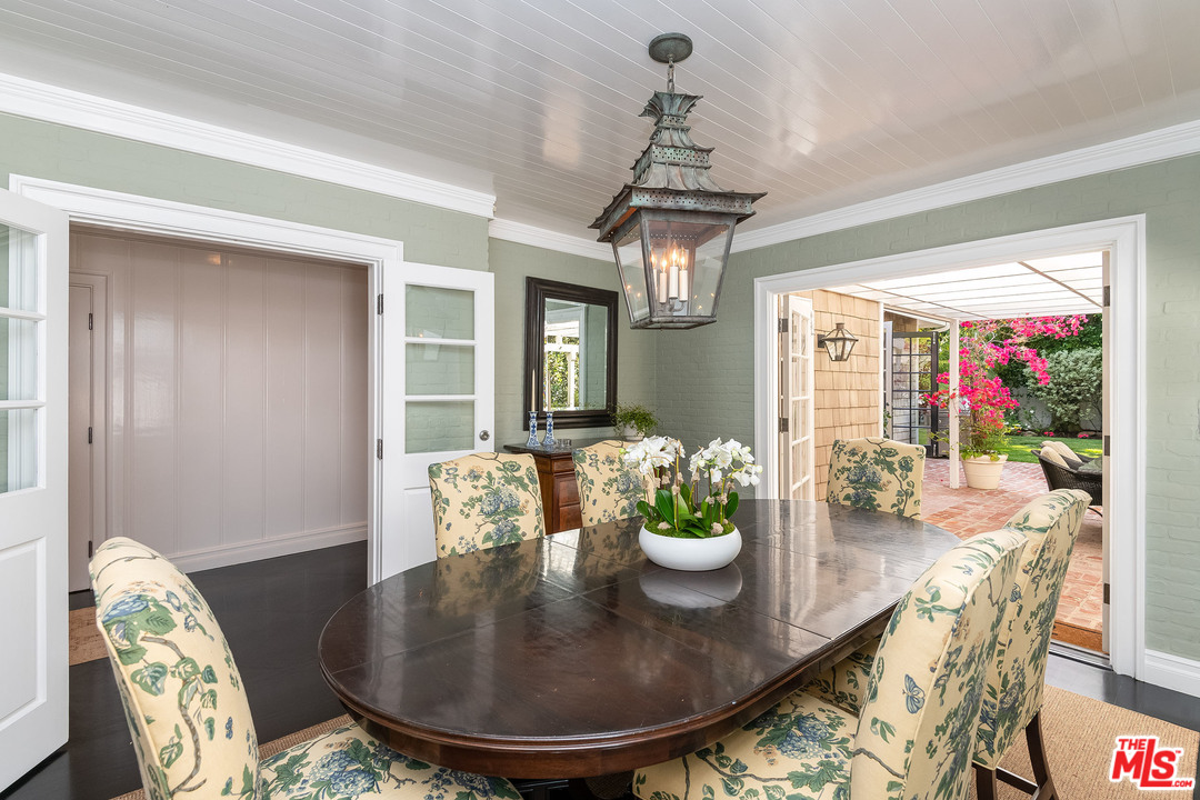 120 Homewood Road Los Angeles, CA 90049 - Photo 33 of 47 a view of a dining room with furniture wooden floor and chandelier