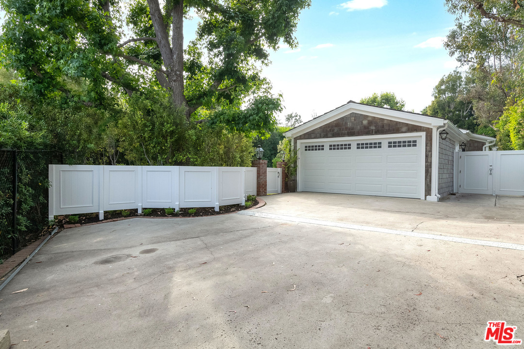 120 Homewood Road Los Angeles, CA 90049 - Photo 36 of 47 a front view of a house with a garage