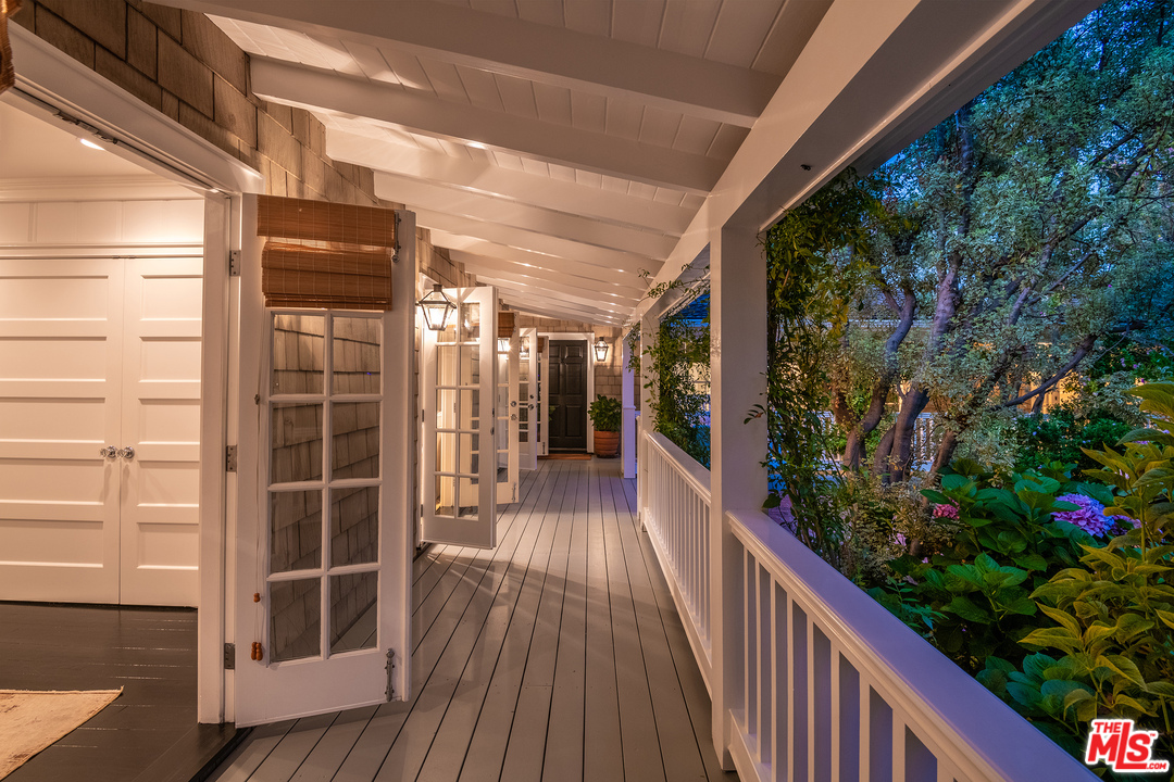 120 Homewood Road Los Angeles, CA 90049 - Photo 5 of 47 a view of a house with a porch