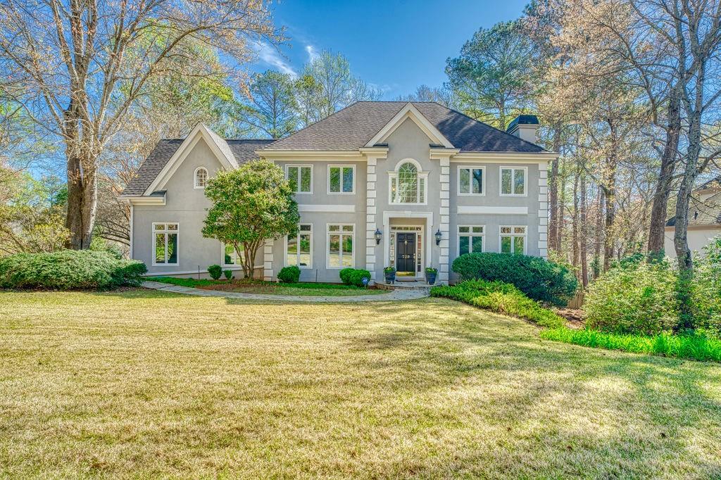 739 Terrell Crossing Marietta, GA 30067 - Photo 1 of 1 a front view of a house with a garden and trees