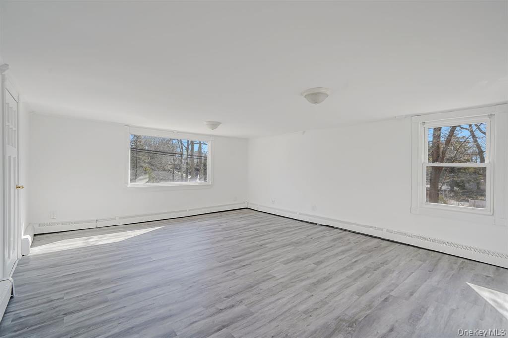 7 Yucca Road, Unit UPPR Rocky Point, NY 11778 - Photo 12 of 18 an empty room with wooden floor and windows