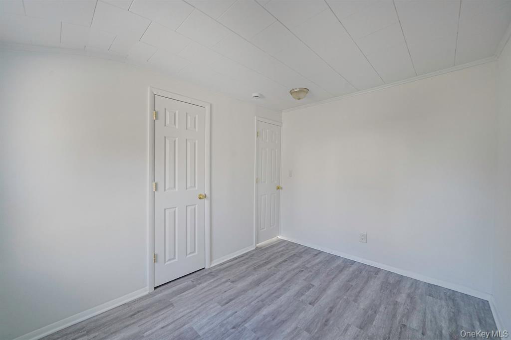 7 Yucca Road, Unit UPPR Rocky Point, NY 11778 - Photo 13 of 18 a view of an empty room with wooden floor
