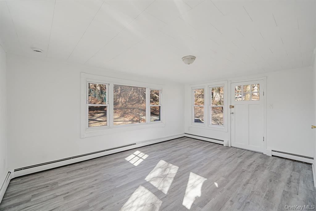 7 Yucca Road, Unit UPPR Rocky Point, NY 11778 - Photo 14 of 18 an empty room with wooden floor and windows