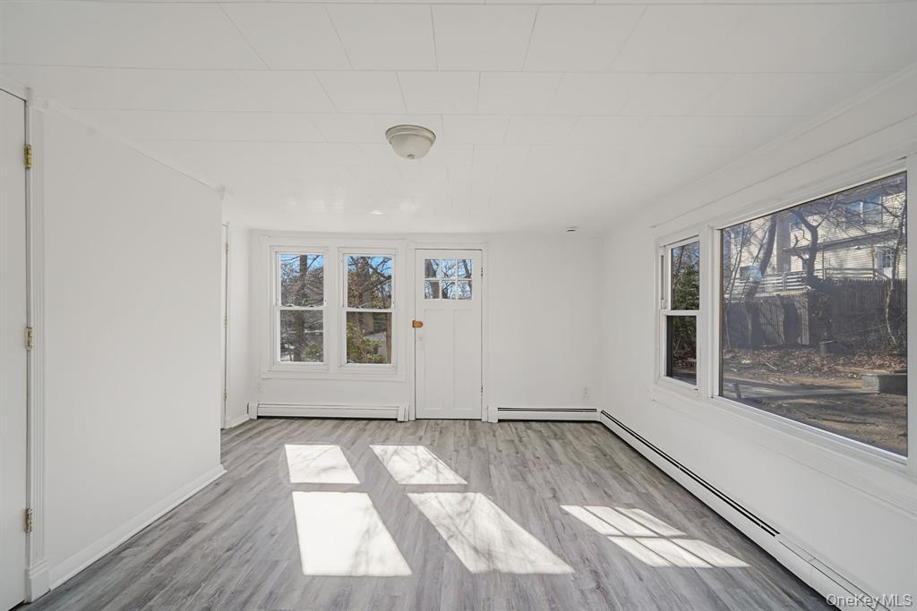 7 Yucca Road, Unit UPPR Rocky Point, NY 11778 - Photo 15 of 18 an empty room with wooden floor and windows