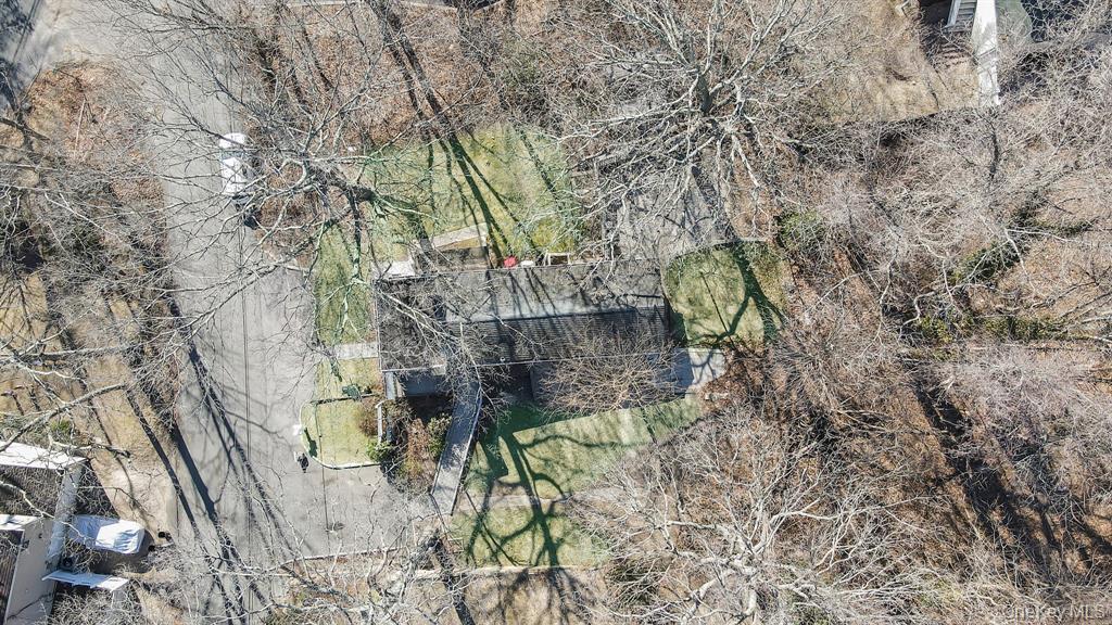 7 Yucca Road, Unit UPPR Rocky Point, NY 11778 - Photo 17 of 18 a backyard of a building with large trees