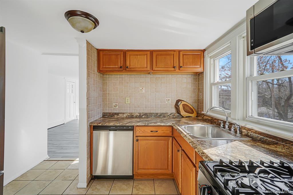 7 Yucca Road, Unit UPPR Rocky Point, NY 11778 - Photo 6 of 18 a kitchen with stainless steel appliances granite countertop a sink stove and refrigerator