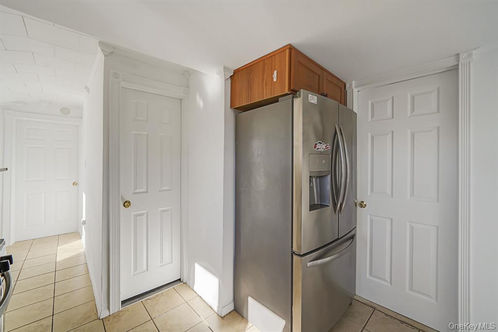 7 Yucca Road, Unit UPPR Rocky Point, NY 11778 - Photo 7 of 18 a metallic refrigerator freezer sitting in a kitchen