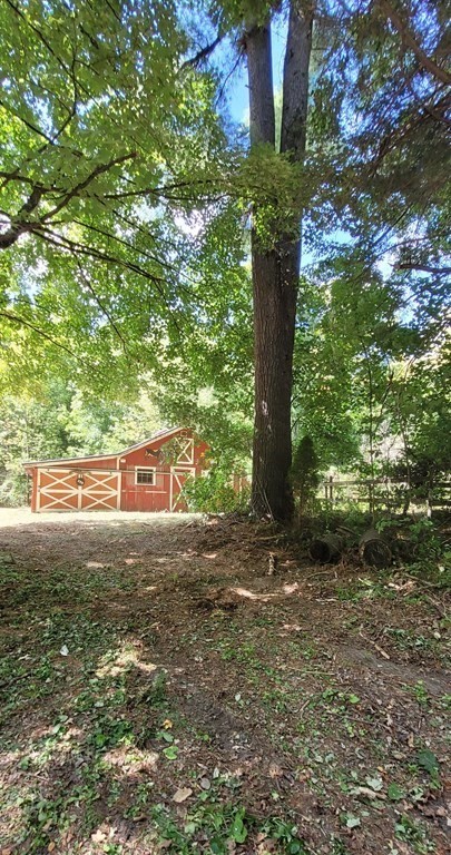 225 Gulf Road Belchertown, MA 01007 - Photo 1 of 32 a view of a yard with plants and large trees