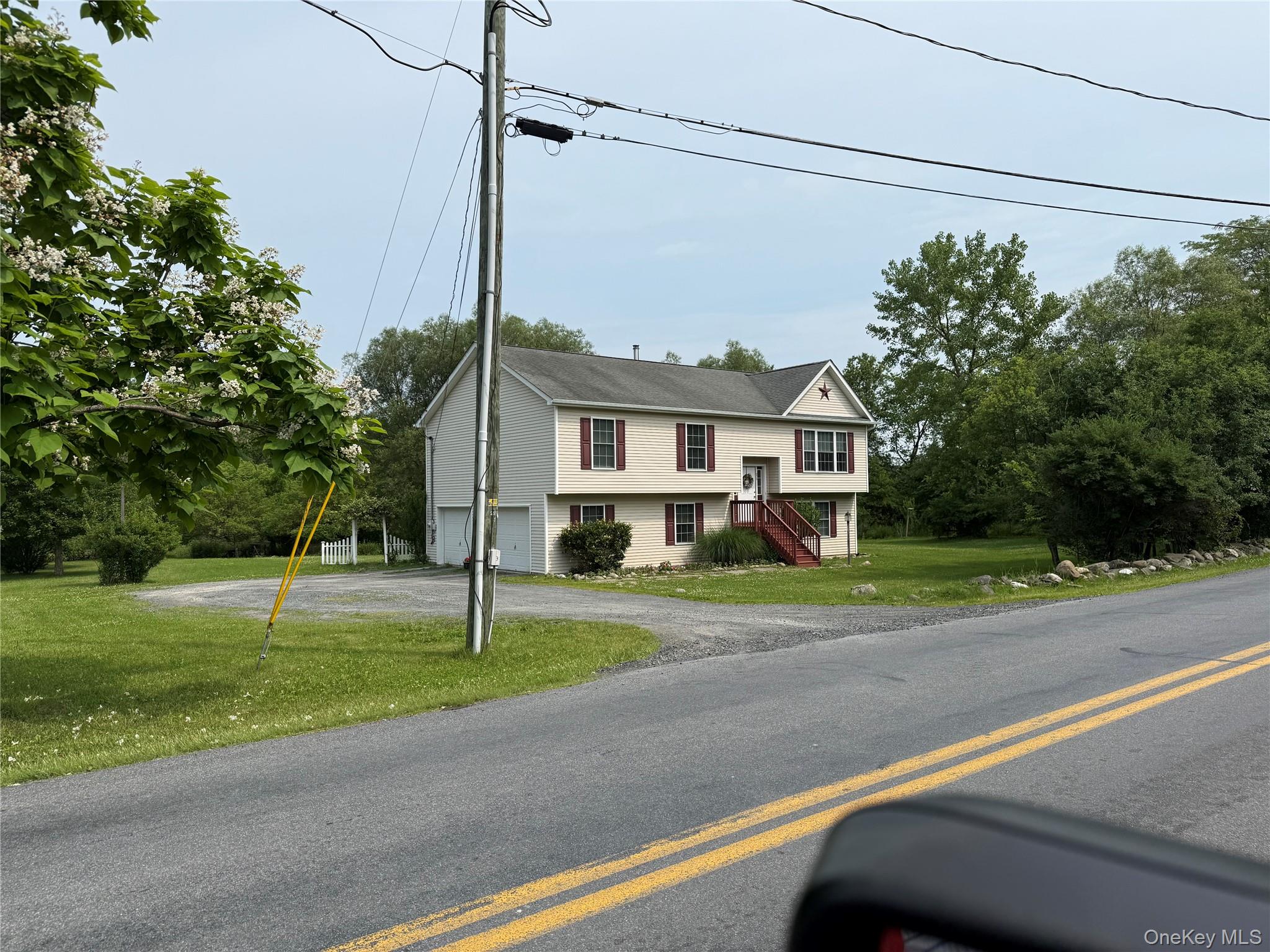 214 Cheechunk Road Goshen, NY 10924 - Photo 1 of 1 Raised ranch featuring a front yard, driveway, an attached garage, and stairway
