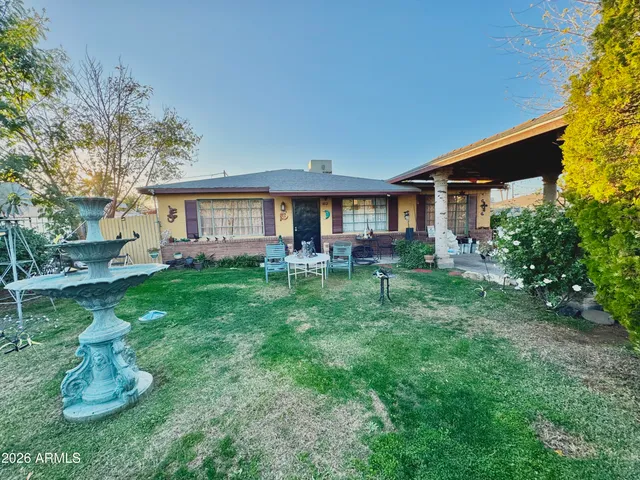 a front view of house with a garden and patio