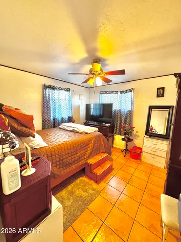 a bedroom with a bed and wooden floor