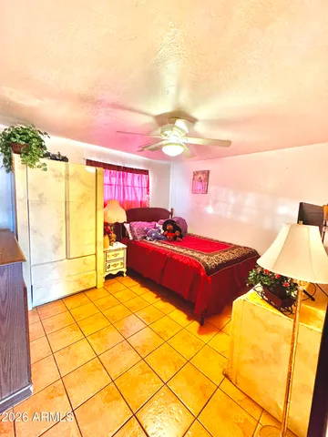 a spacious bedroom with a bed and a night stand