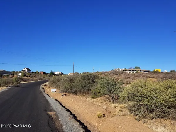 a view of a lush green hillside and a building