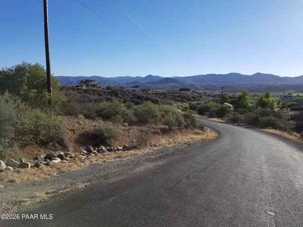 a view of a lush green hillside and a houses