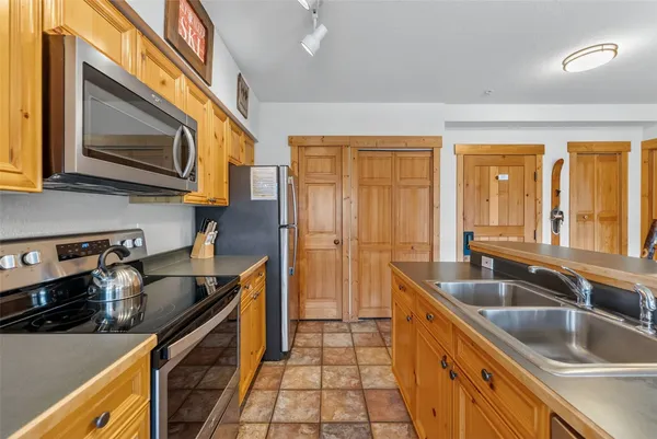 a kitchen with stainless steel appliances granite countertop a sink stove and microwave