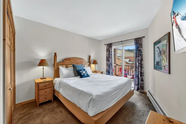 a bedroom with a bed next to a window
