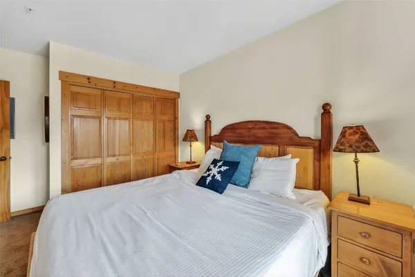 a bedroom with a bed and two night stand